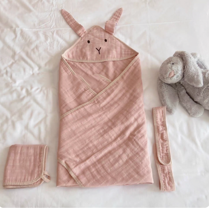 Bunny Soft Pink hooded cotton muslin baby swaddle wrap set with matching belt and cloth displayed flat on bed