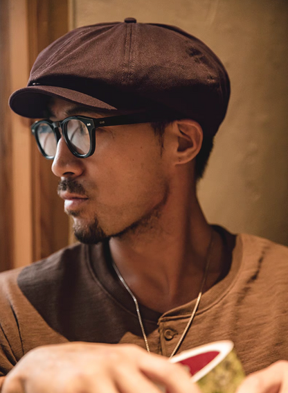 Hudson Cotton Blend Newsboy Cap coffee red worn in lifestyle reading scene showcasing timeless newsboy silhouette comfortable fit and polished everyday style