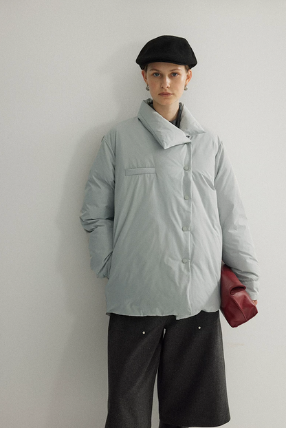 Ice Blue down jacket snapped closed along the asymmetric placket, with folded collar