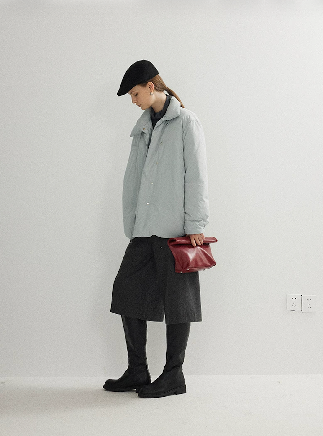 Side view of an Ice Blue hip-length down jacket with stand collar and dropped shoulders
