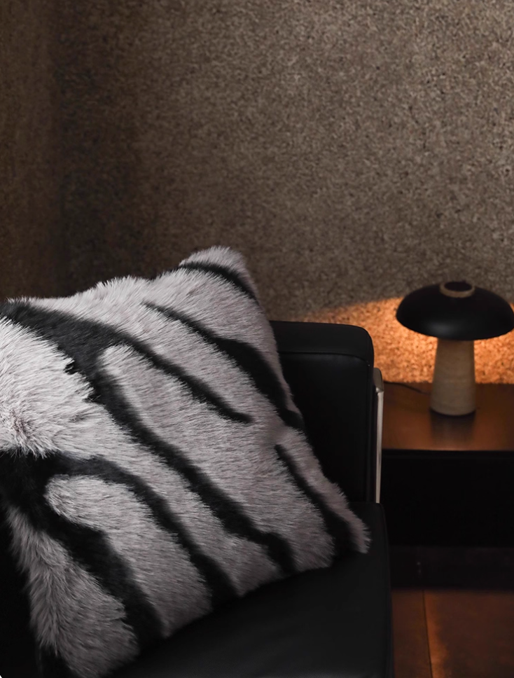 Decorative faux fur zebra pillow gray black stripe on black sofa modern décor