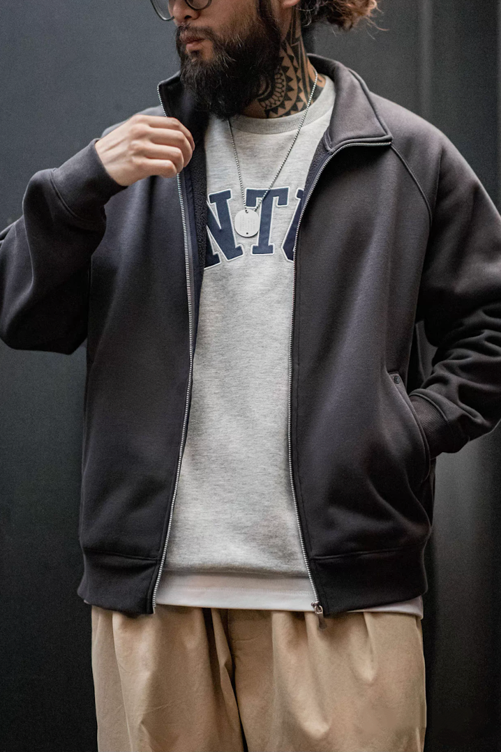 Charcoal zip sweatshirt jacket layered over gray crewneck sweater