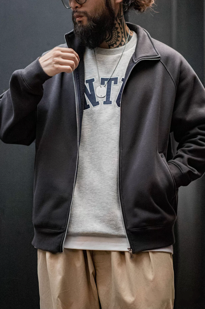 Charcoal zip sweatshirt jacket layered over gray crewneck sweater