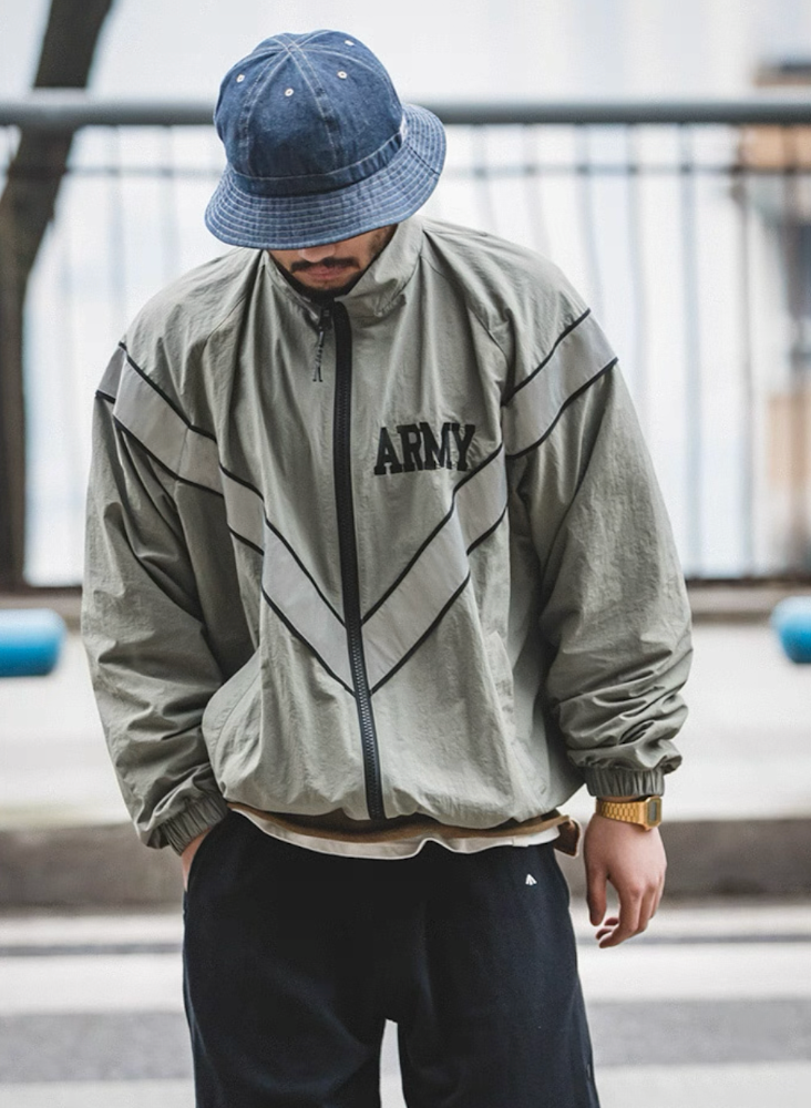 Model styling khaki gray ARMY training jacket in casual streetwear outdoors.