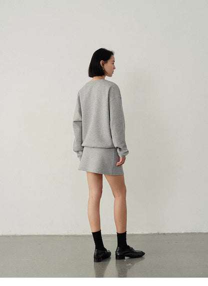 Back view of women’s oversized hoodie &amp; skirt set in light gray