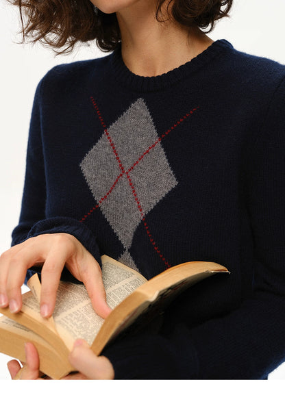 Close-up of navy wool argyle crewneck while the model flips through an open book.