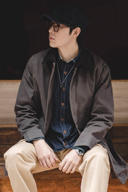 Model wearing vintage waxed cotton coat with casual outfit