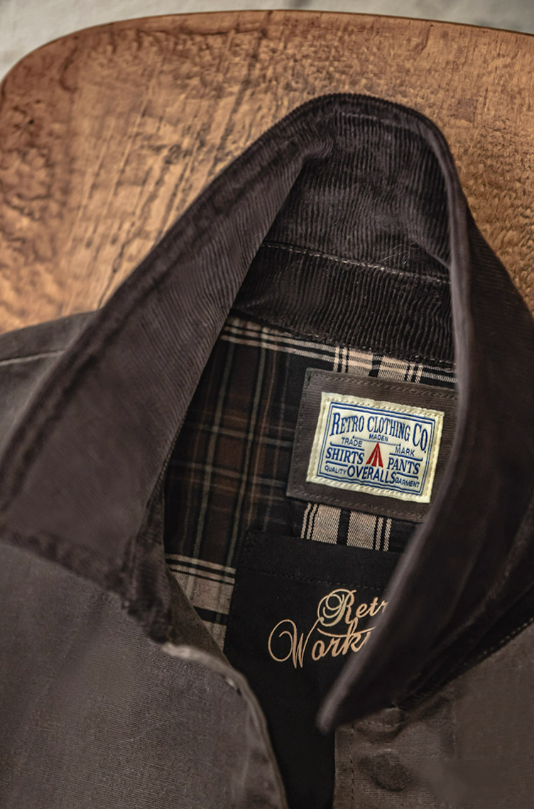 Close-up of corduroy collar and retro brand label on waxed coat