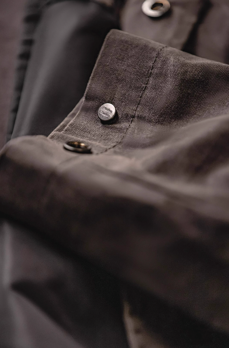 Heritage waxed cotton coat button and stitching detail