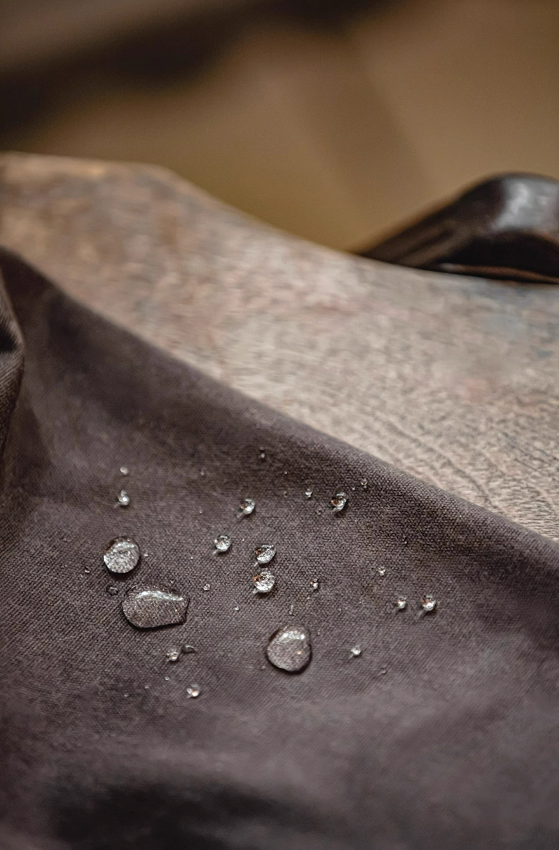 Water droplets showing water-resistant waxed cotton fabric