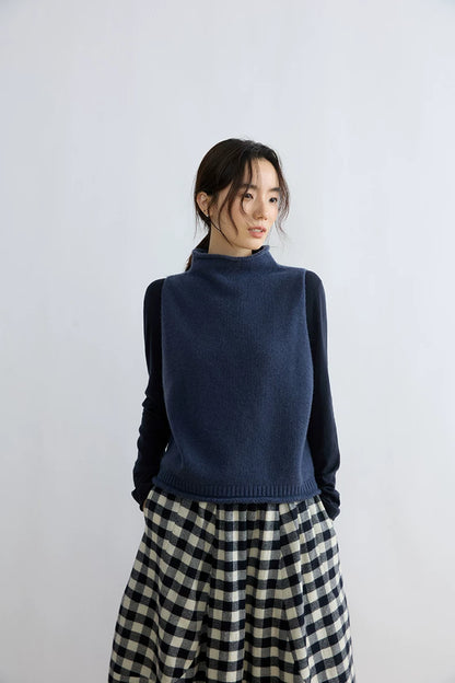 Close-up of Ink Blue 100% wool sweater vest showing rolled mock neck and ribbed hem
