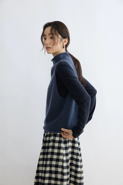 Side view of Ink Blue sleeveless wool vest showing the armhole and cropped waist-length cut