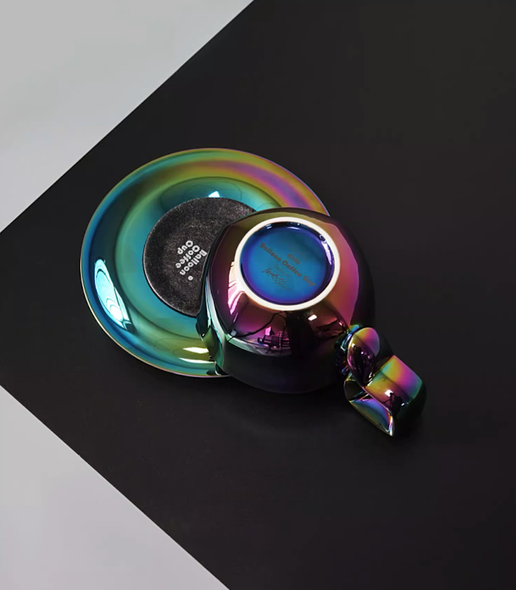 Aurora Black iridescent balloon-handle ceramic coffee mug and saucer, bottom view showing base detail and dark reflective finish