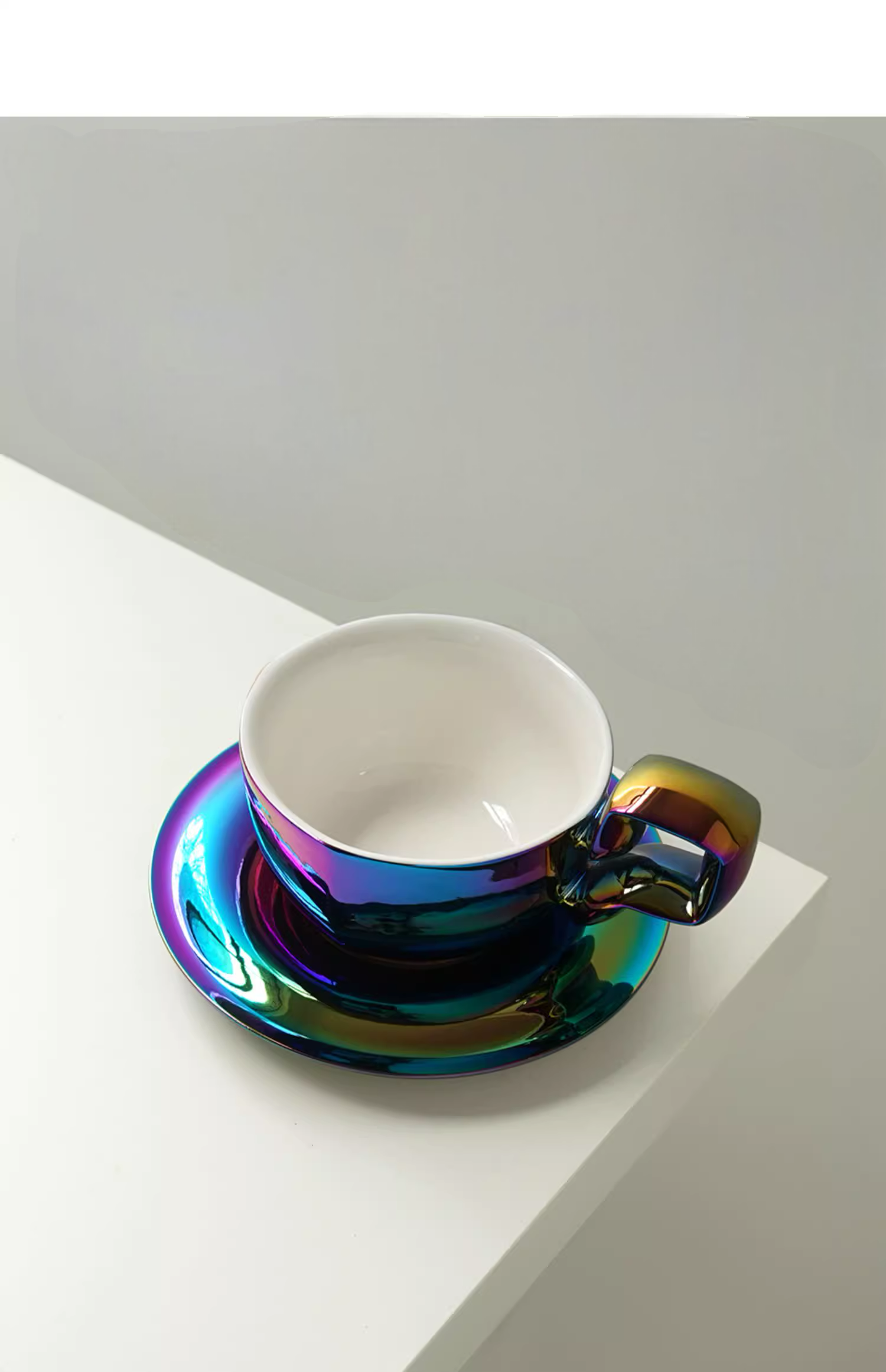 Iridescent Peacock Blue balloon-handle ceramic coffee mug with saucer, front view with glossy color-shifting surface