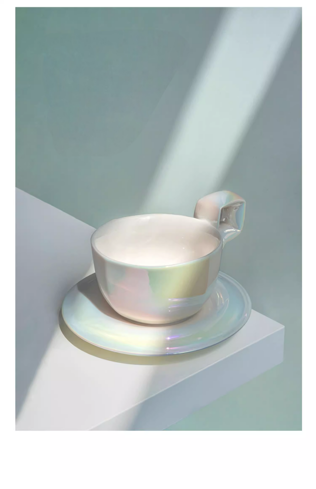Pearlized Mother of Pearl White ceramic coffee mug with saucer, angled view showing balloon-style handle and glossy iridescent finish