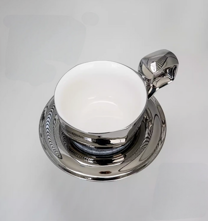 Space Silver iridescent balloon-handle ceramic coffee mug with saucer, top view showing smooth white interior and reflective metallic finish