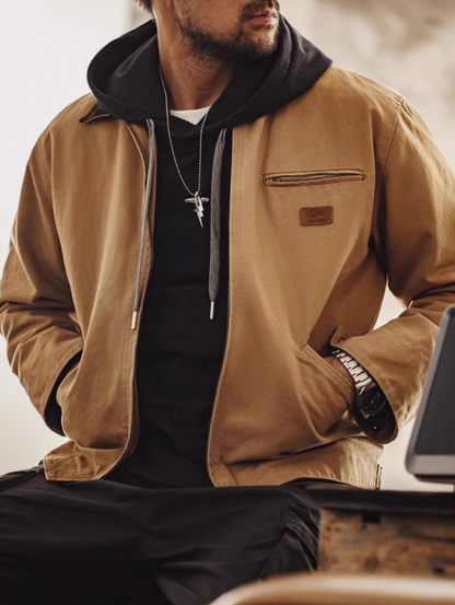 Ironclad Canvas Work Jacket khaki casual sitting look styled with hoodie and pants showing everyday layering and functional comfort