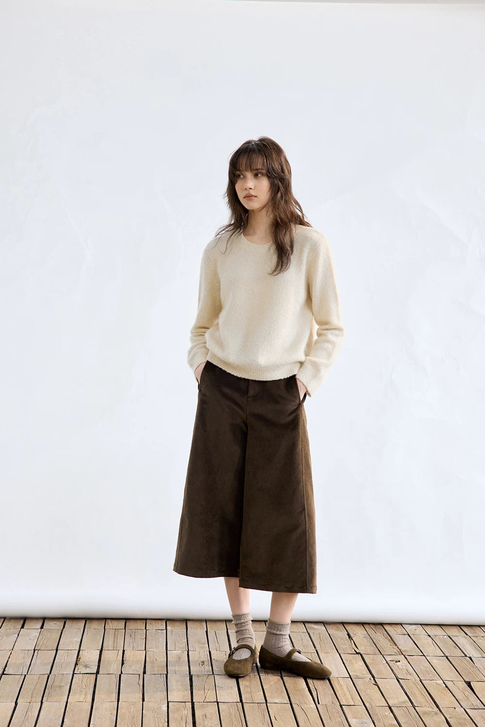 Ivory cashmere sweater, full-length front view styled with wide-leg pants