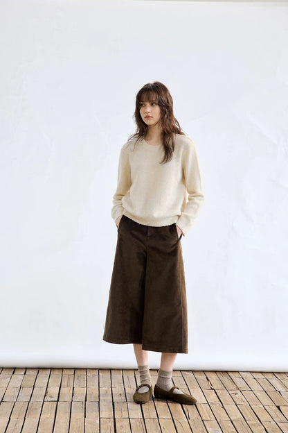 Ivory cashmere sweater, full-length front view styled with wide-leg pants