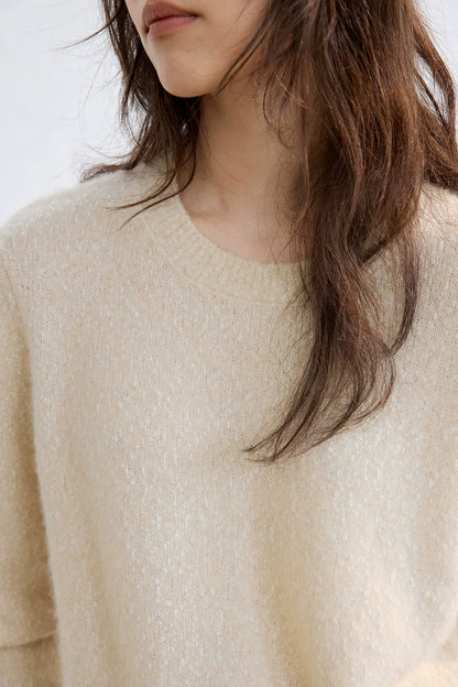 Ivory flecked cashmere sweater, close-up of round neckline