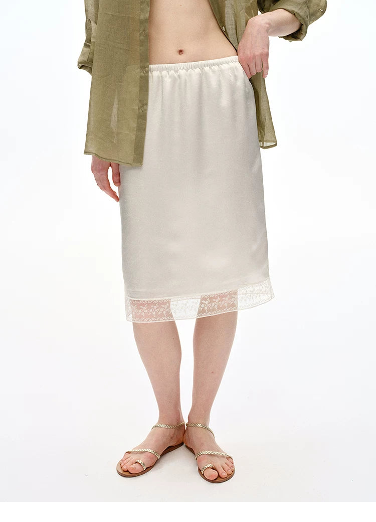 Three-quarter view of Ivory slip skirt showing floral lace hem band