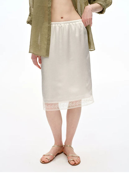 Three-quarter view of Ivory slip skirt showing floral lace hem band