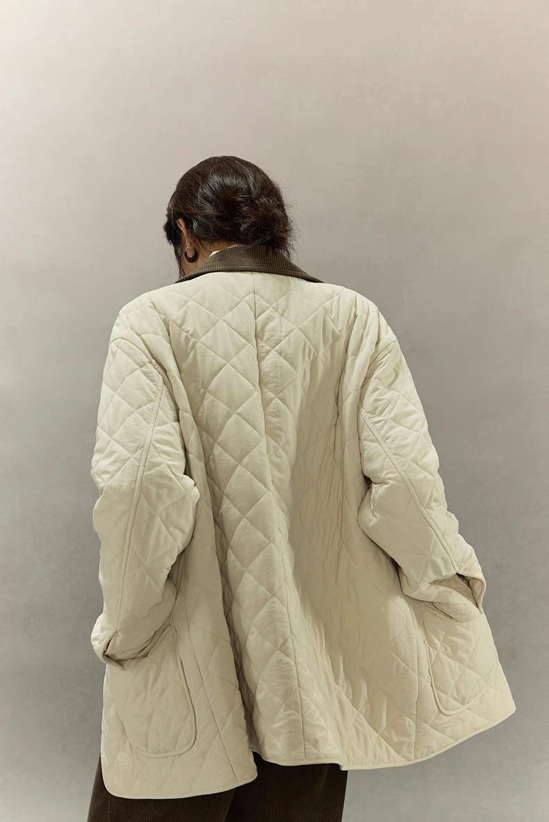 back view of mid-length cream quilted coat with diamond stitching