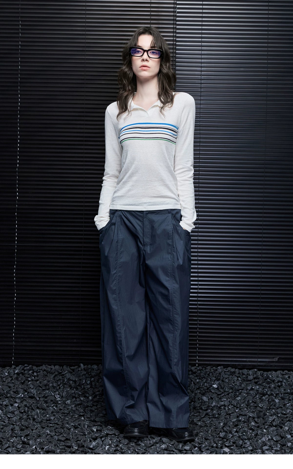 Full-length front view of Ivory Stripe knit polo sweater styled with navy wide-leg trousers