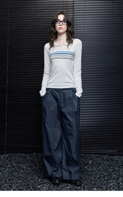 Full-length front view of Ivory Stripe knit polo sweater styled with navy wide-leg trousers