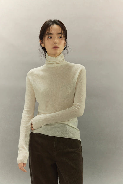 Model wearing Ivory White seamless cashmere-silk turtleneck, full-body front view.
