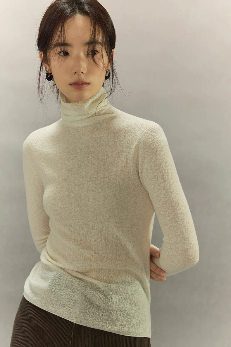Ivory White bark-texture turtleneck close-front view, soft natural lighting.
