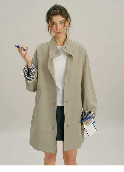 Front view of a Khaki mac coat with snap placket and rolled gingham-lined sleeves