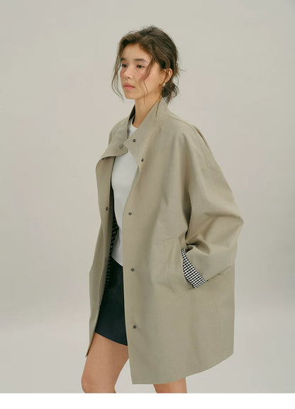 Three-quarter view of an open Khaki mac coat with dropped shoulders and slanted pocket