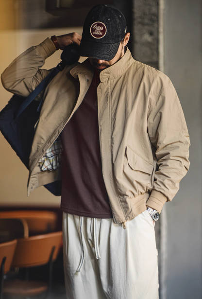 Man styling khaki Harrington jacket with flap pocket detail