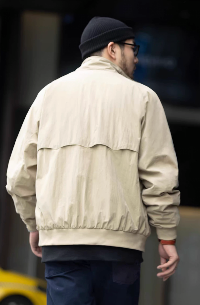 Back view of men’s khaki Harrington jacket with umbrella vent design