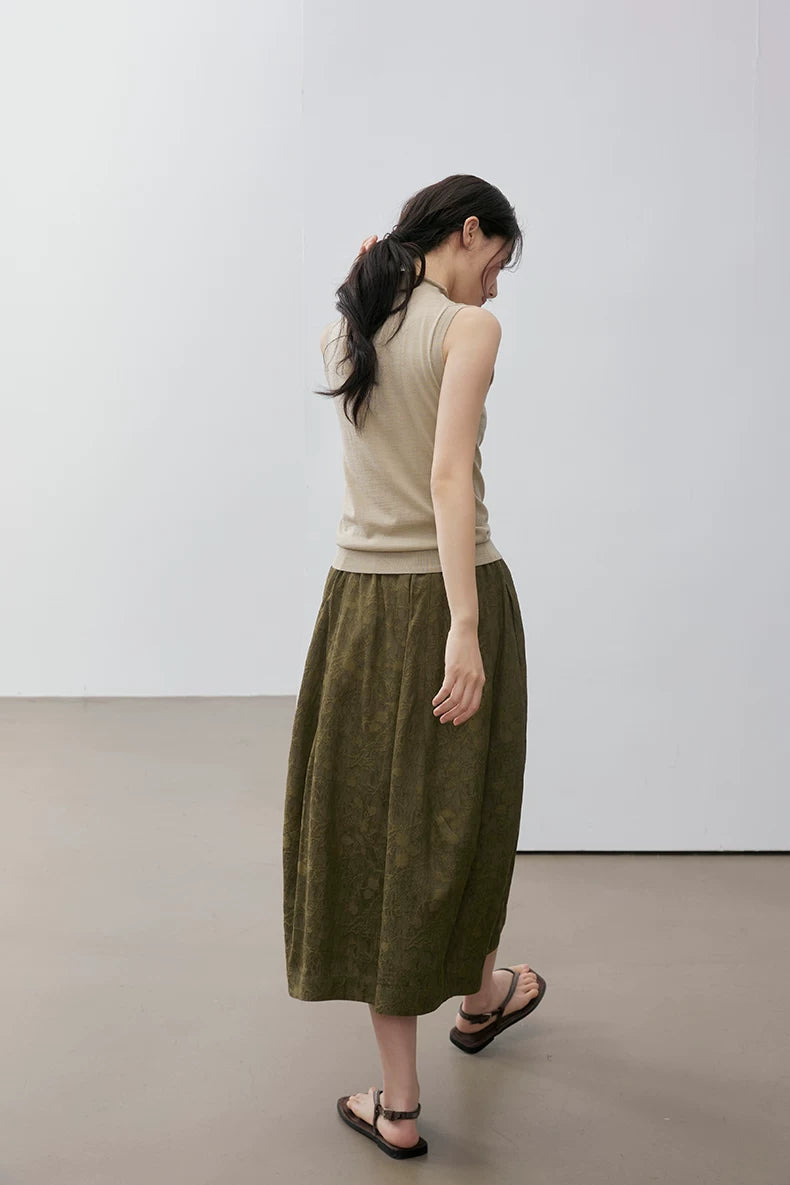 Back view of model walking in Khaki sleeveless mock neck knit top
