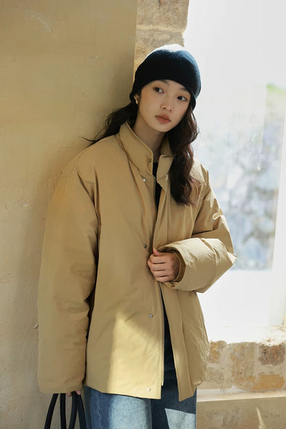 Khaki matte down jacket with stand collar, snap placket, and elasticated inner cuff