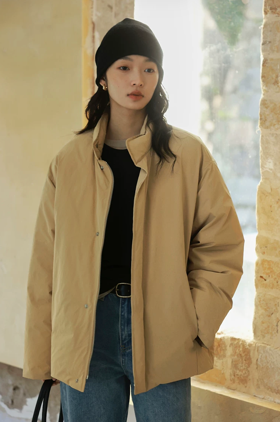 Front view of a Khaki down jacket worn open, with snap placket and side pocket