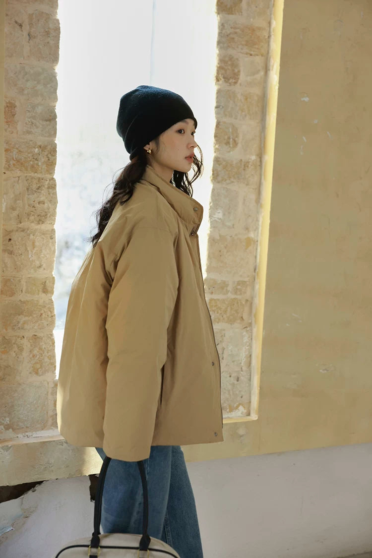 Side profile of a Khaki stand-collar down jacket with dropped shoulders