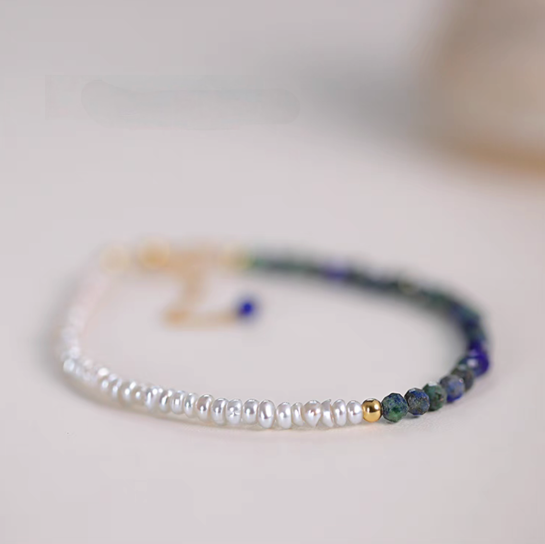 Lapis pearl bracelet in natural color flat lay featuring freshwater pearls and natural lapis stone beads with gold accent