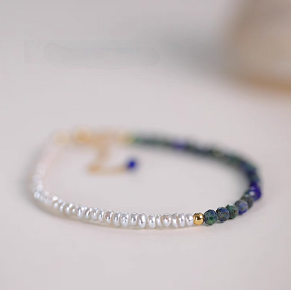 Lapis pearl bracelet in natural color flat lay featuring freshwater pearls and natural lapis stone beads with gold accent