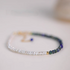 Lapis pearl bracelet in natural color flat lay featuring freshwater pearls and natural lapis stone beads with gold accent