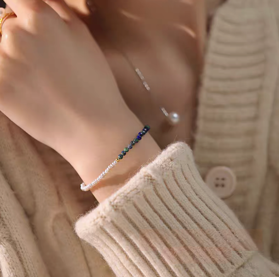 Lapis pearl bracelet in natural color worn on wrist with knit sweater highlighting elegant pearl and natural stone combination