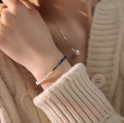 Lapis pearl bracelet in natural color worn on wrist with knit sweater highlighting elegant pearl and natural stone combination