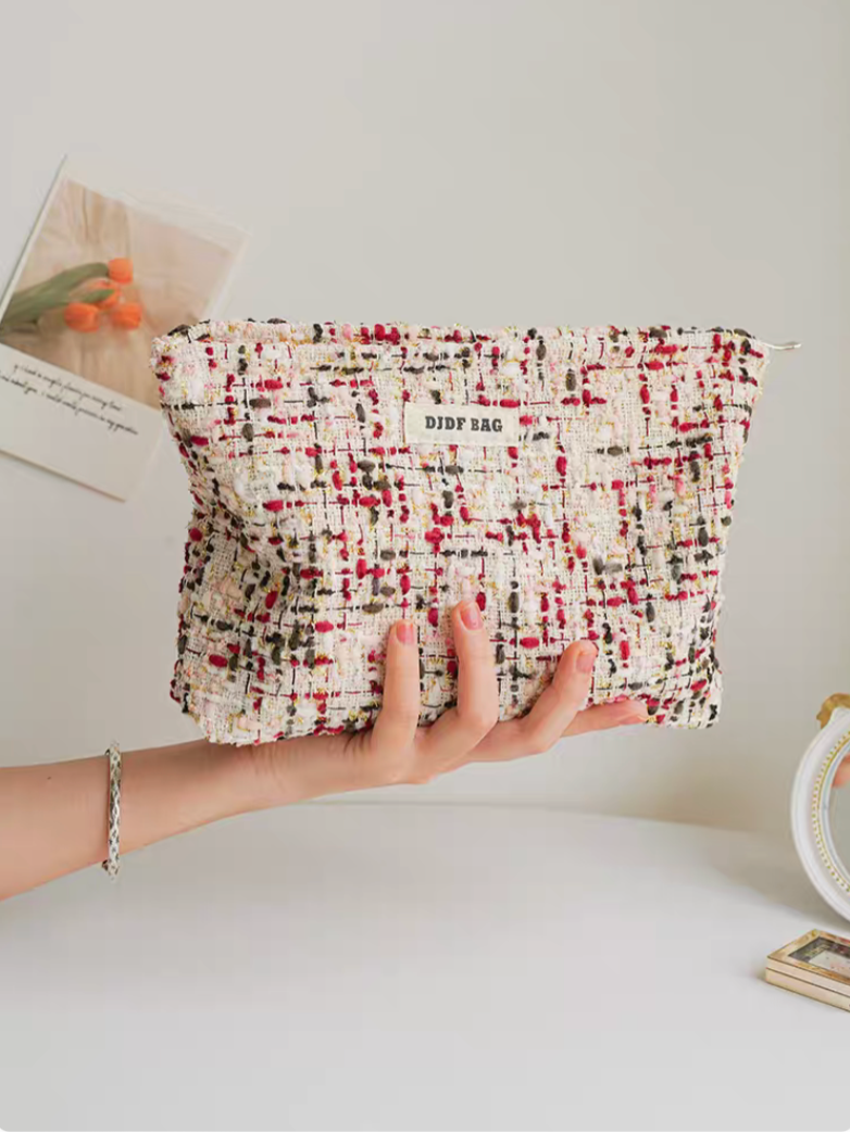 Large Capacity Travel Makeup Bag in purple woven texture held in hand showing full front shape and fabric detail