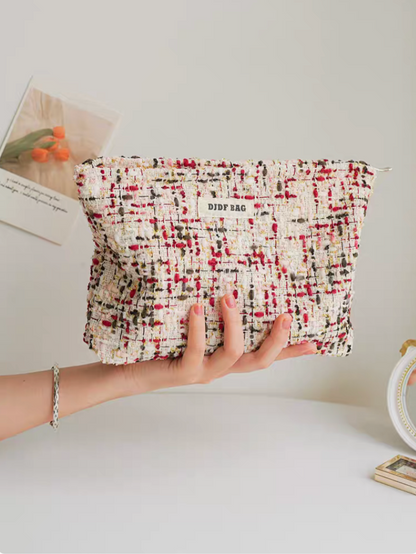 Large Capacity Travel Makeup Bag in purple woven texture held in hand showing full front shape and fabric detail