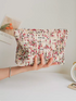 Large Capacity Travel Makeup Bag in purple woven texture held in hand showing full front shape and fabric detail
