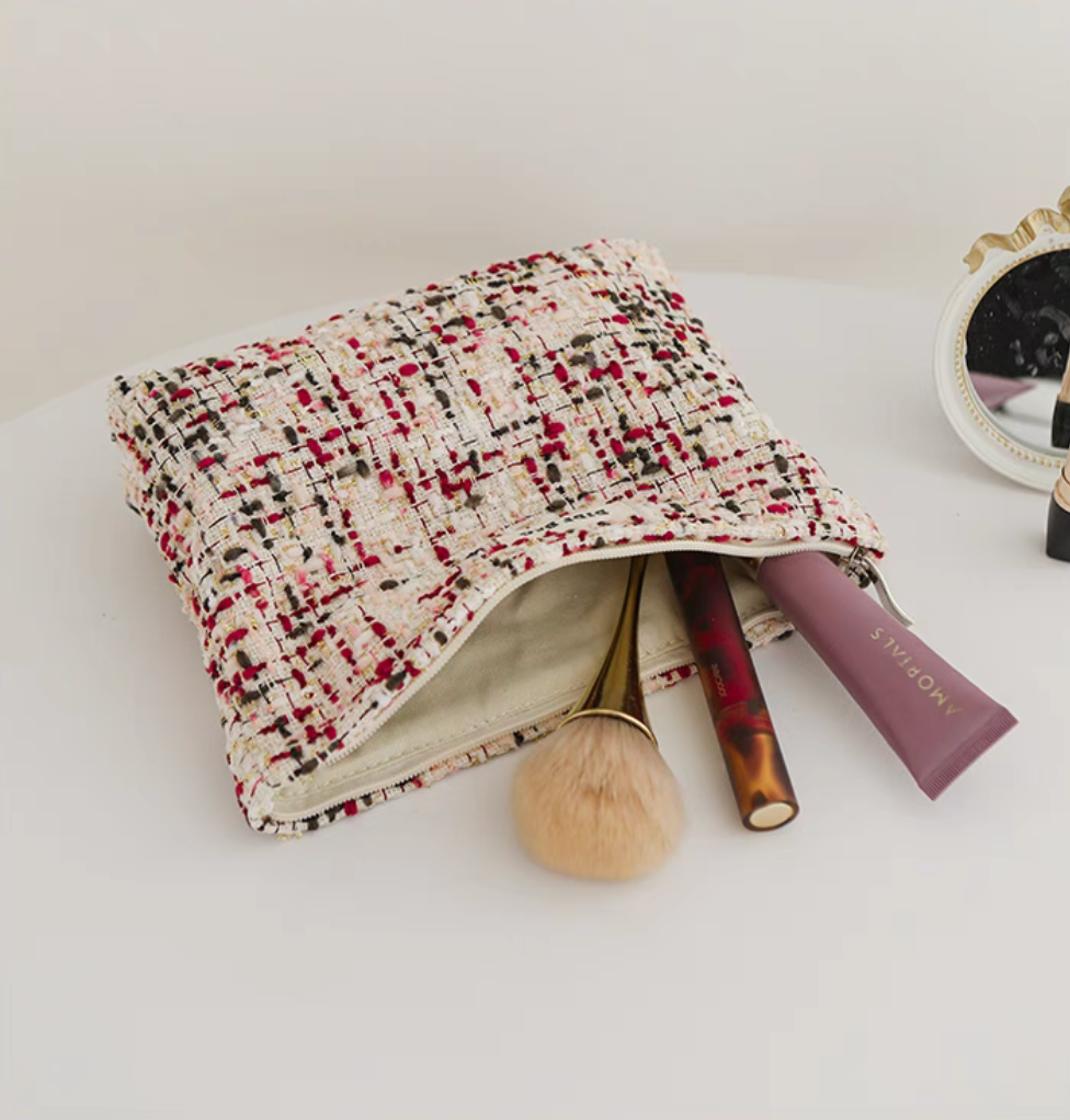 Large Capacity Travel Makeup Bag in purple woven texture opened with makeup brush and cosmetic tubes inside
