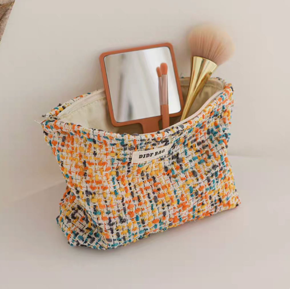 Large Capacity Travel Makeup Bag in yellow woven texture with open top displaying mirror and makeup brush inside