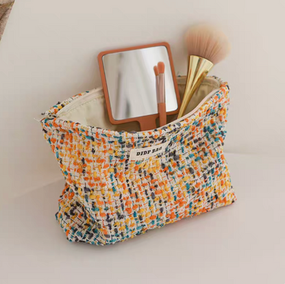 Large Capacity Travel Makeup Bag in yellow woven texture with open top displaying mirror and makeup brush inside